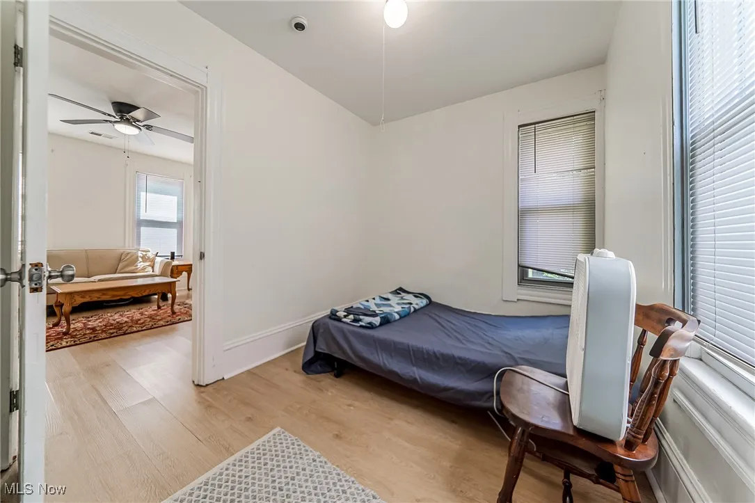 Bedroom featuring light wood-type flooring and multiple windows
