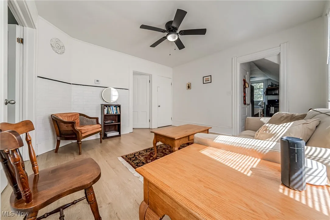 Living room featuring light wood finished floors and a ceiling fan
