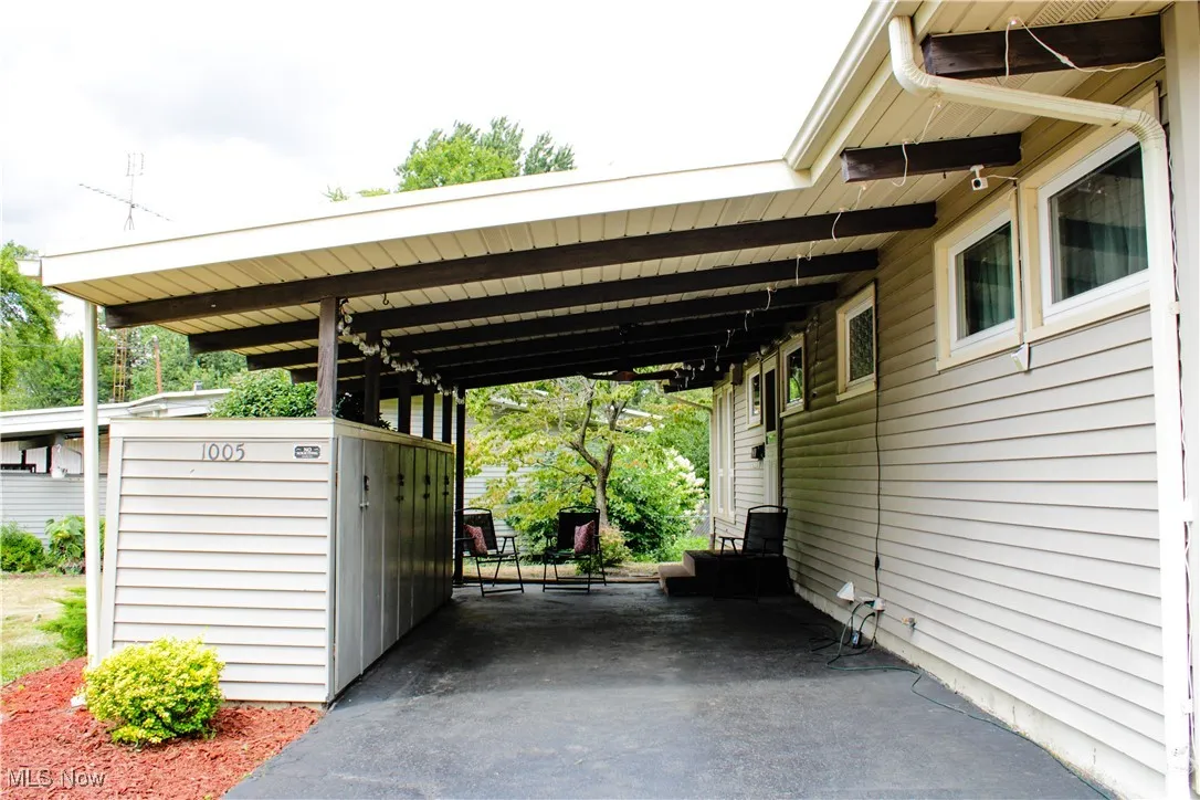 View of parking with an attached carport