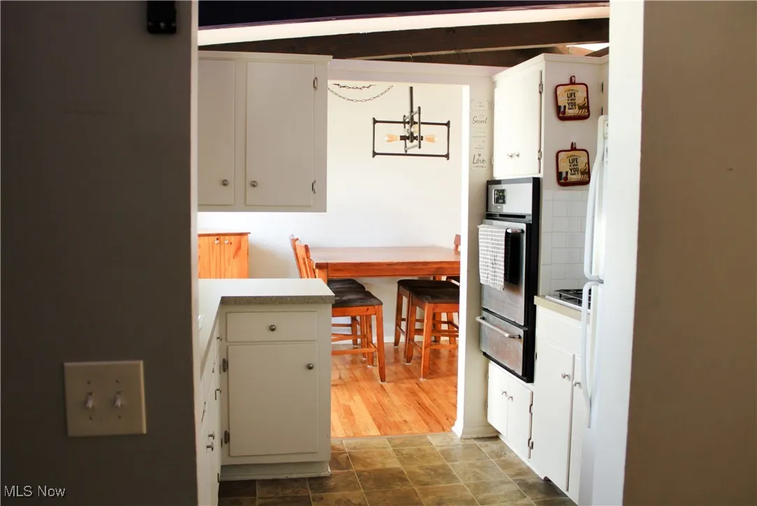 Kitchen with stainless steel oven and cooktop