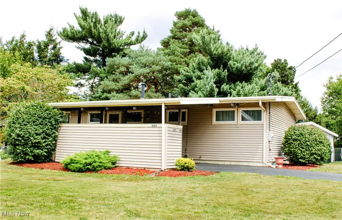 Single story home with asphalt driveway