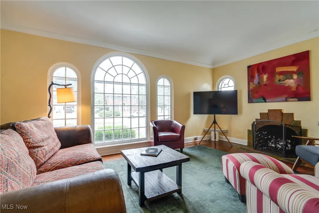 Living area featuring crown molding and wood finished floors