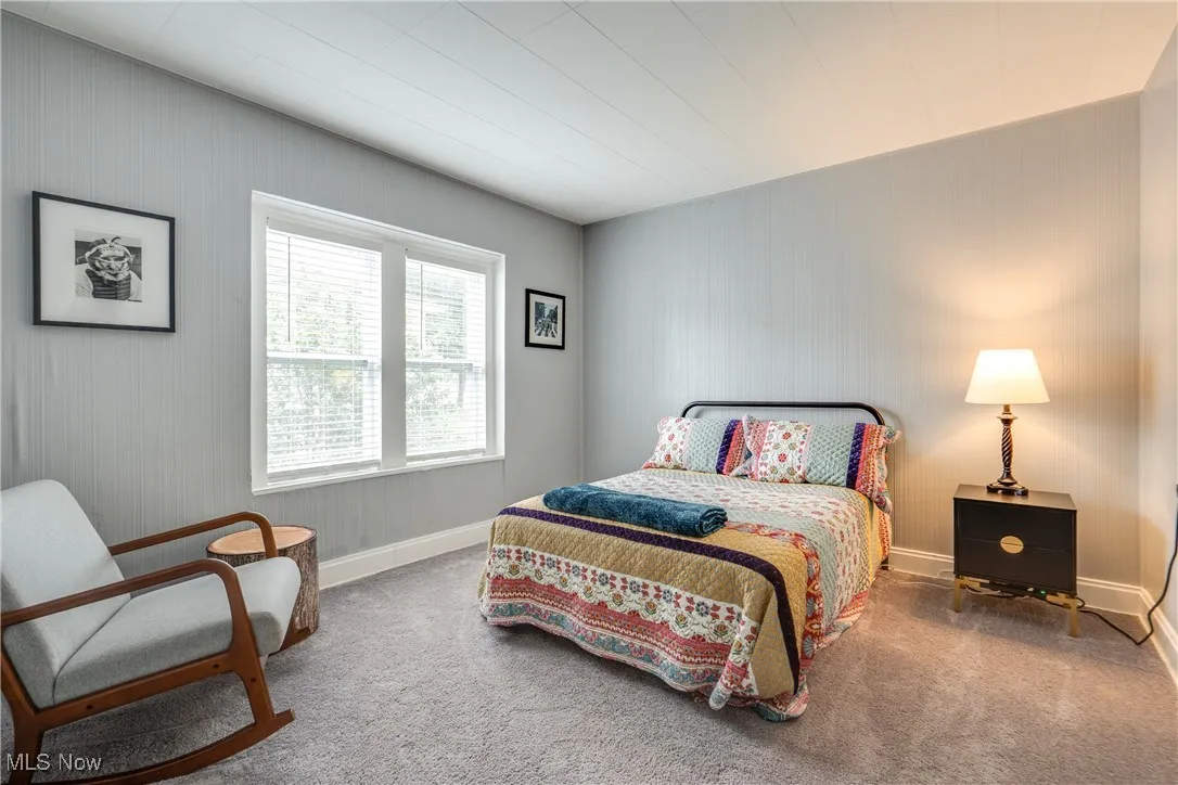 Bedroom featuring carpet flooring and baseboards