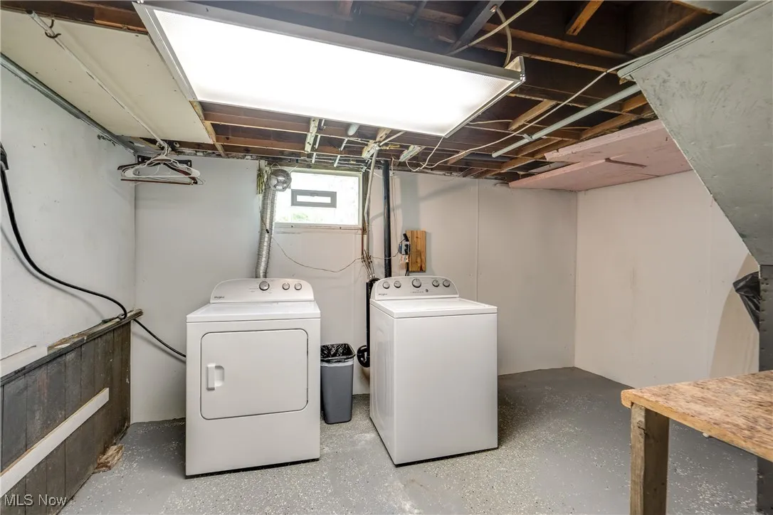 Washroom with washing machine and clothes dryer