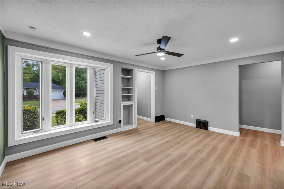 Unfurnished bedroom featuring light wood finished floors, a textured ceiling, a ceiling fan, and recessed lighting