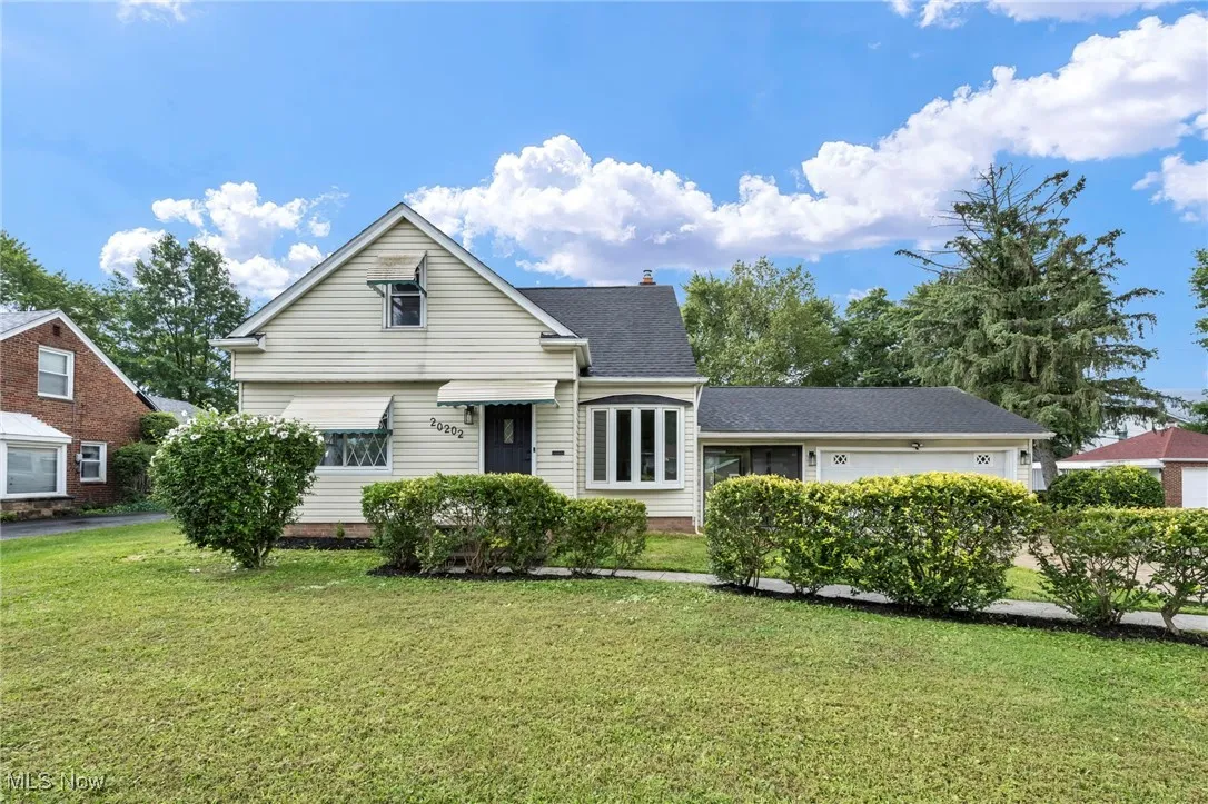View of front of home featuring a front yard and a chimney