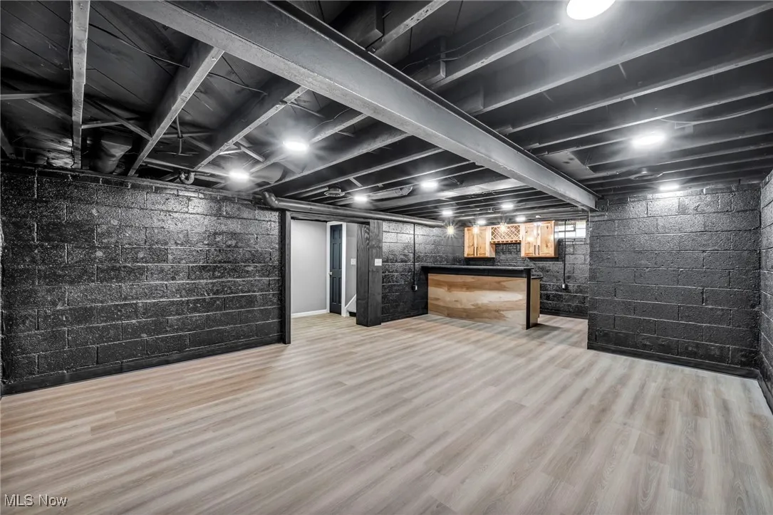 Finished below grade area featuring light wood-type flooring