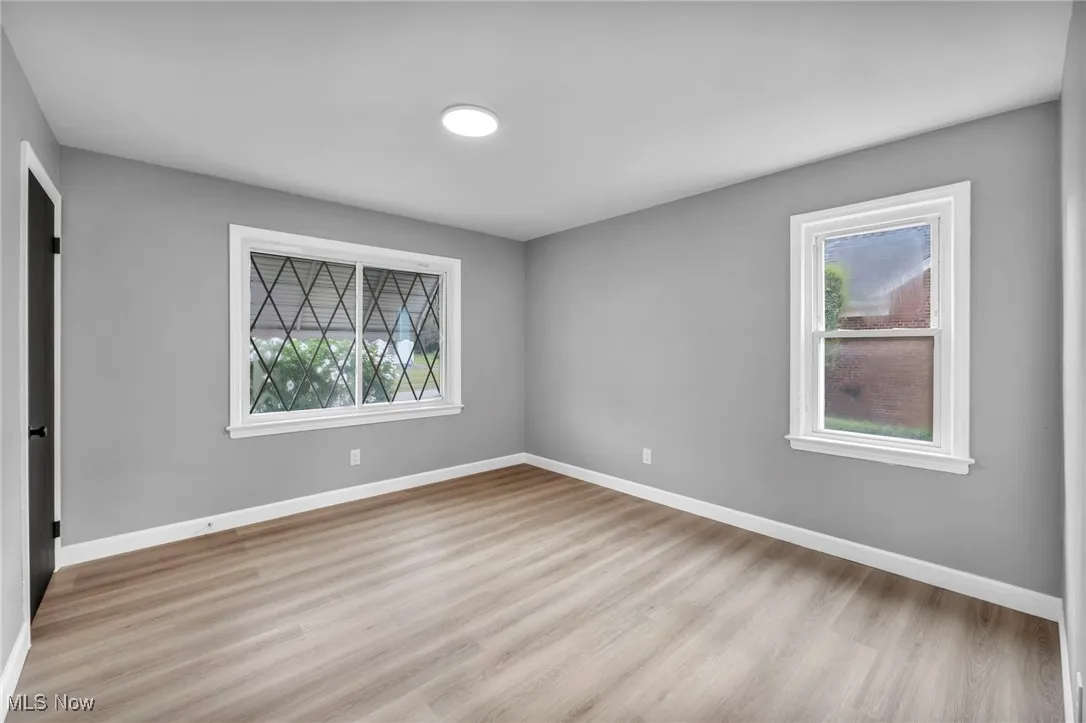 Unfurnished bedroom featuring light wood finished floors and a closet
