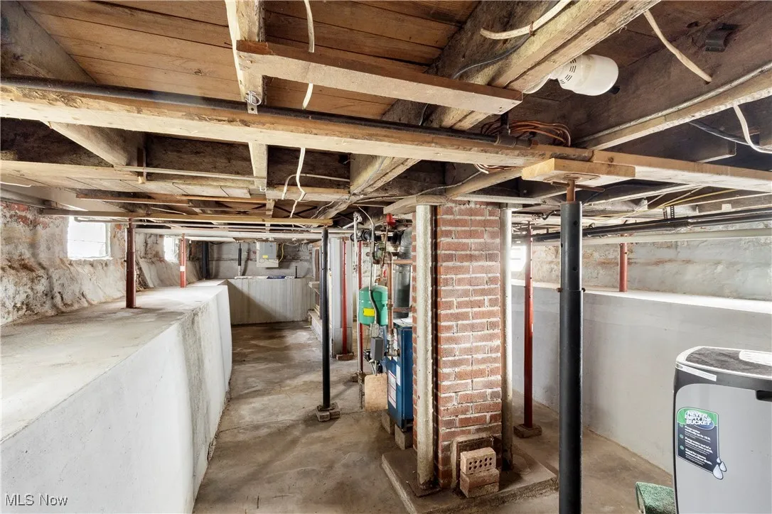 Below grade area with washer / clothes dryer and a heating unit