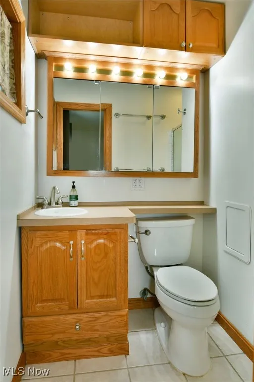 Half bath featuring light tile patterned floors and vanity