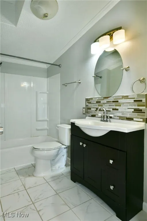 Bathroom featuring a textured ceiling,  shower combination, vanity, light marble finish floors, and backsplash