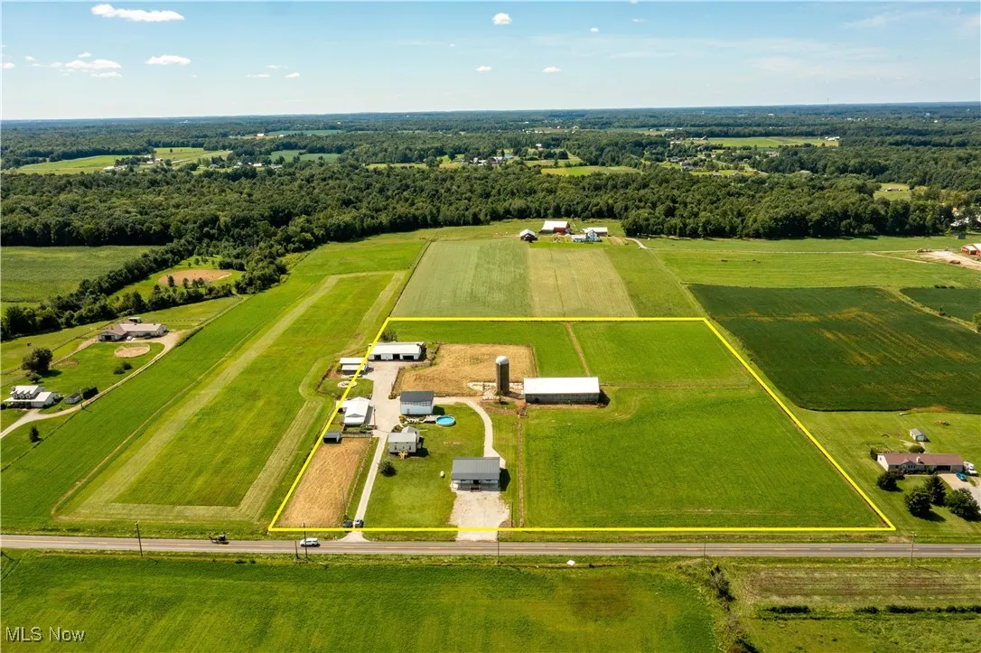 Aerial view of sparsely populated area with rows of crops and property boundaries highlighted