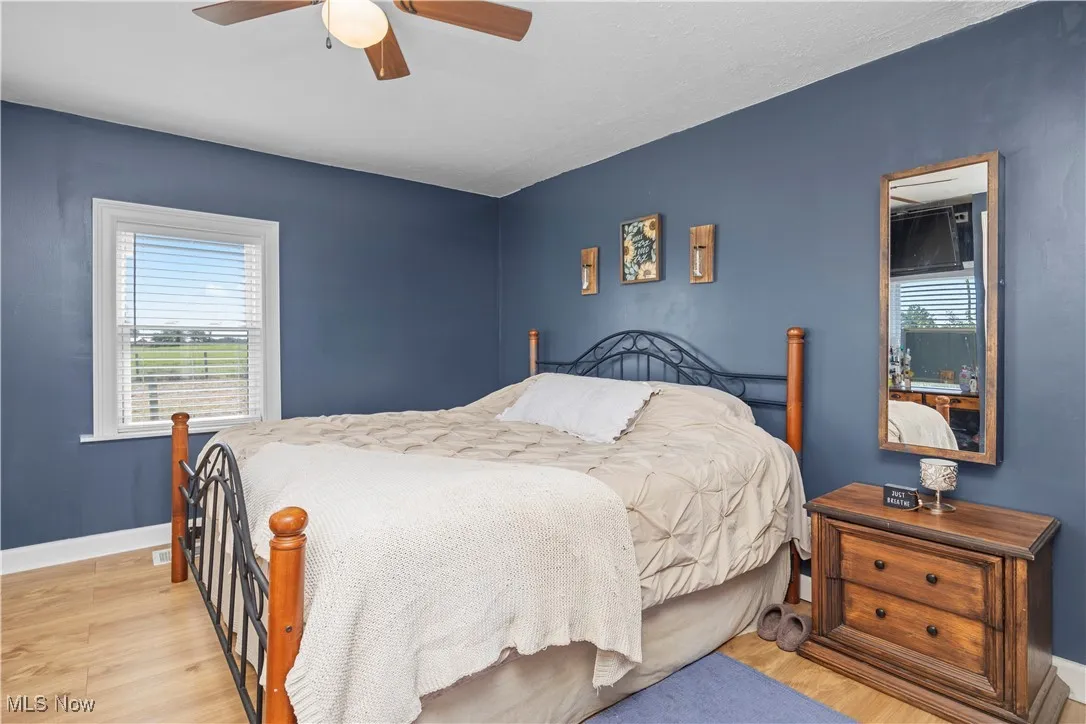 Bedroom featuring wood finished floors and a ceiling fan