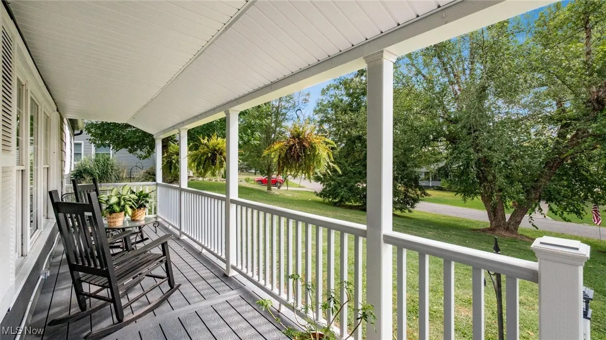 Wooden porch with a lawn