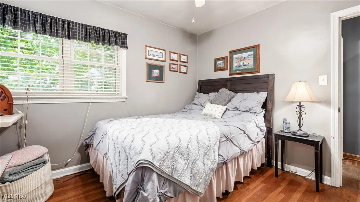 Bedroom featuring dark wood-type flooring and ceiling fan