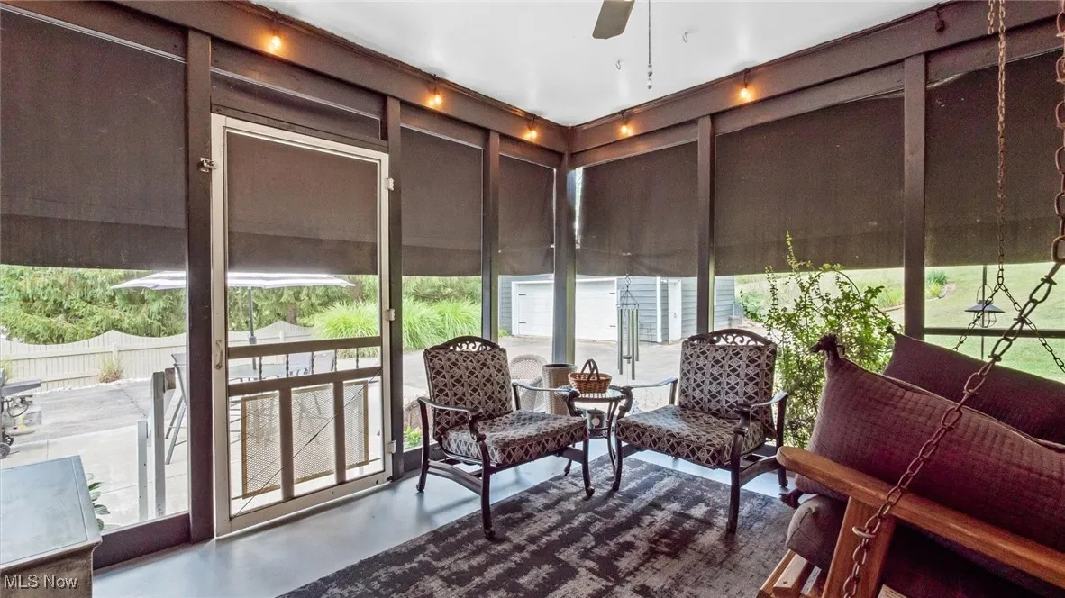 Sunroom featuring a wall of windows and finished concrete flooring