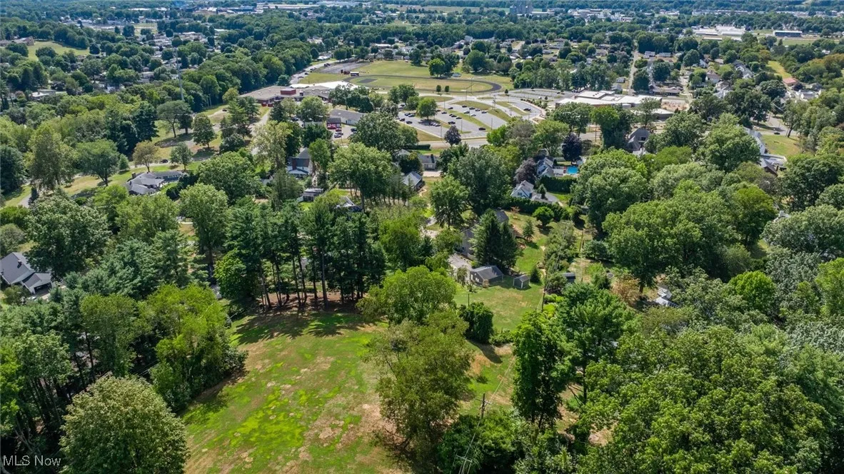 View of property location featuring a tree filled landscape