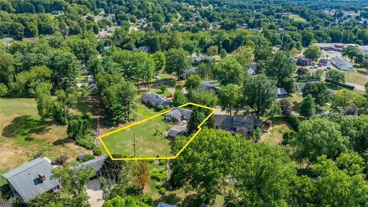 Aerial perspective of suburban area featuring property parcel outlined