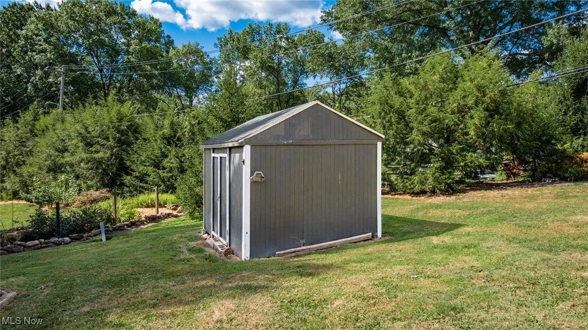 View of shed featuring view of wooded area