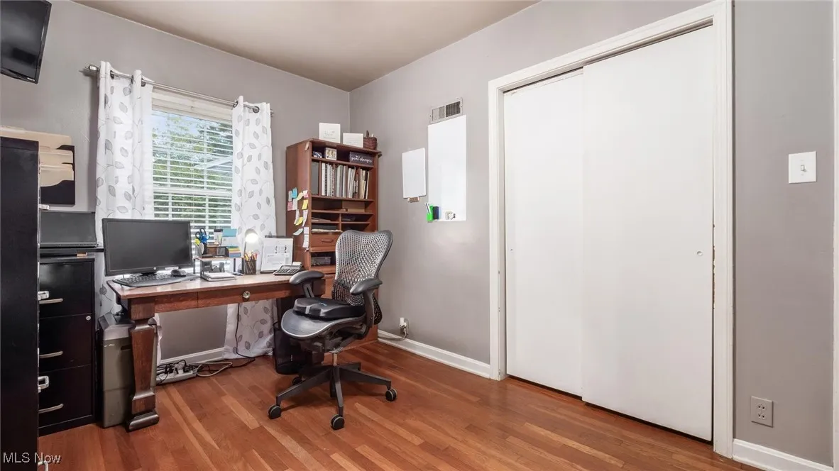 Office space featuring baseboards and wood finished floors