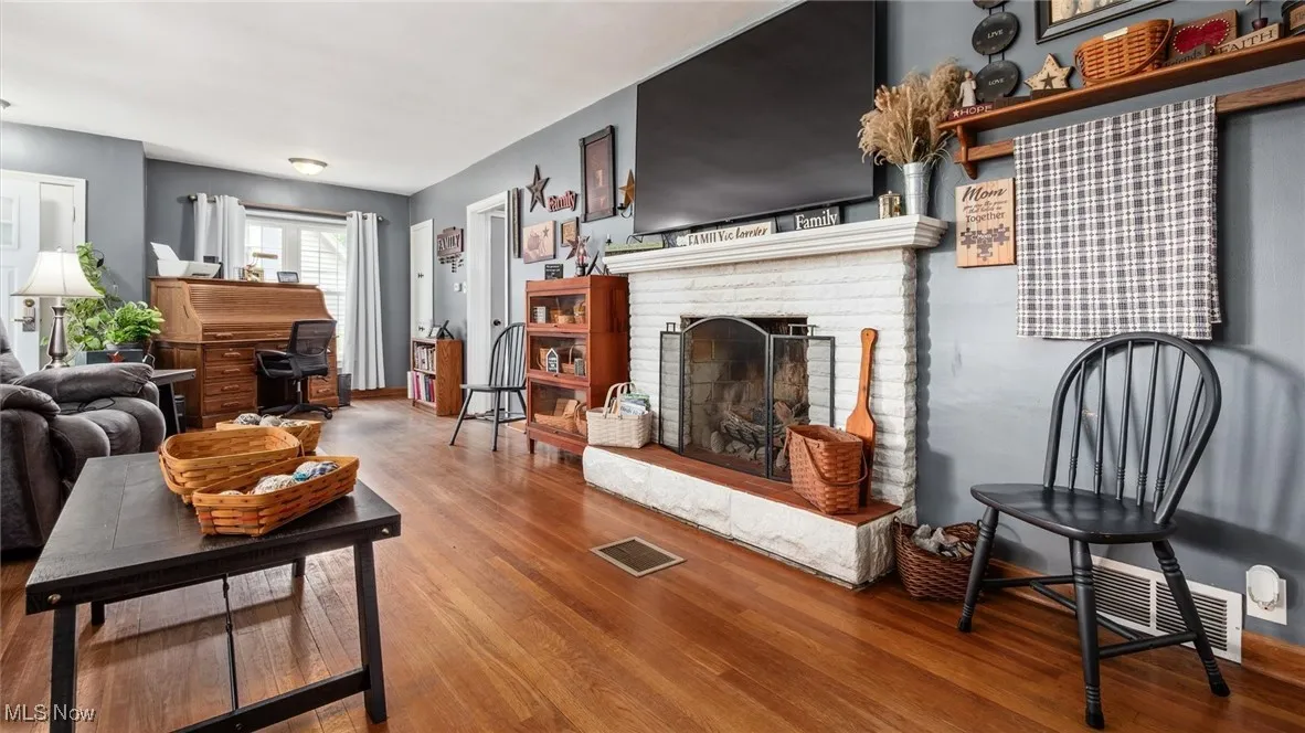 Living room featuring wood finished floors and a fireplace