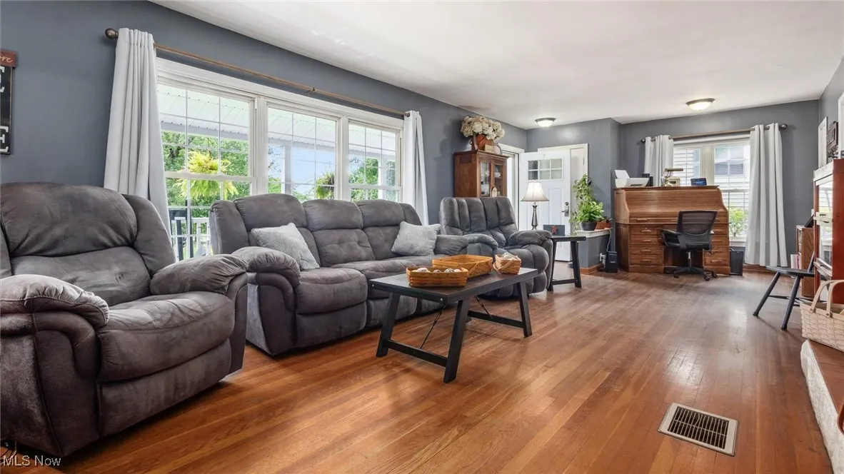Living area featuring wood-type flooring and a desk