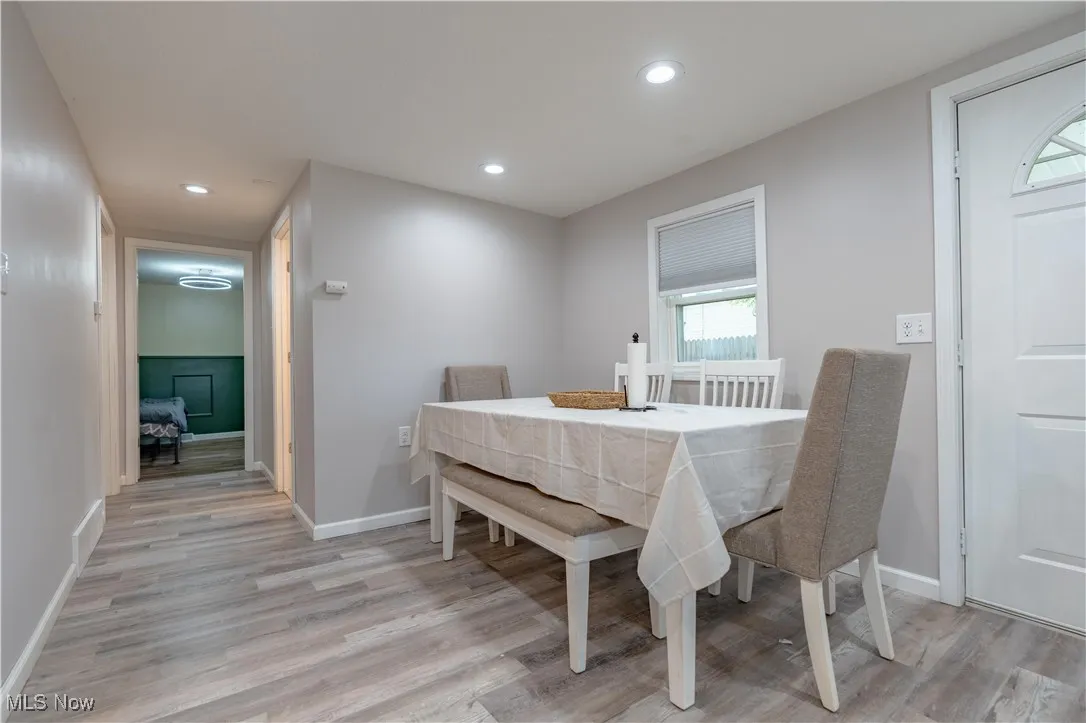 Dining area with recessed lighting and light wood-style flooring