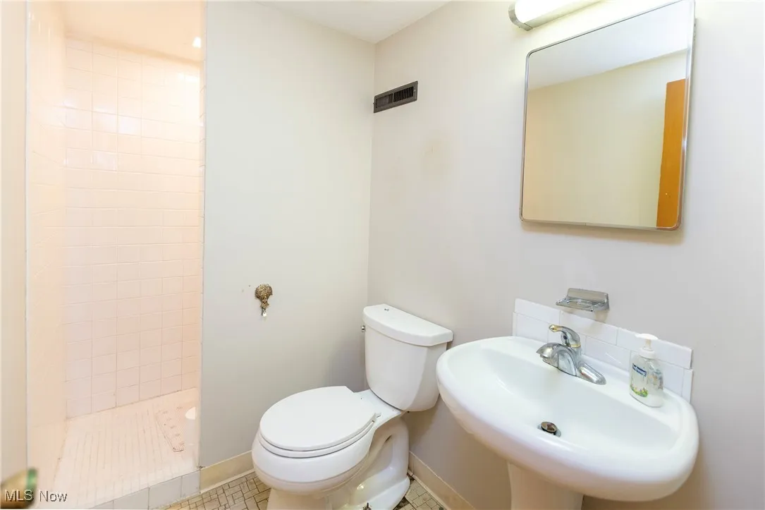 Bathroom with a stall shower and tile patterned flooring