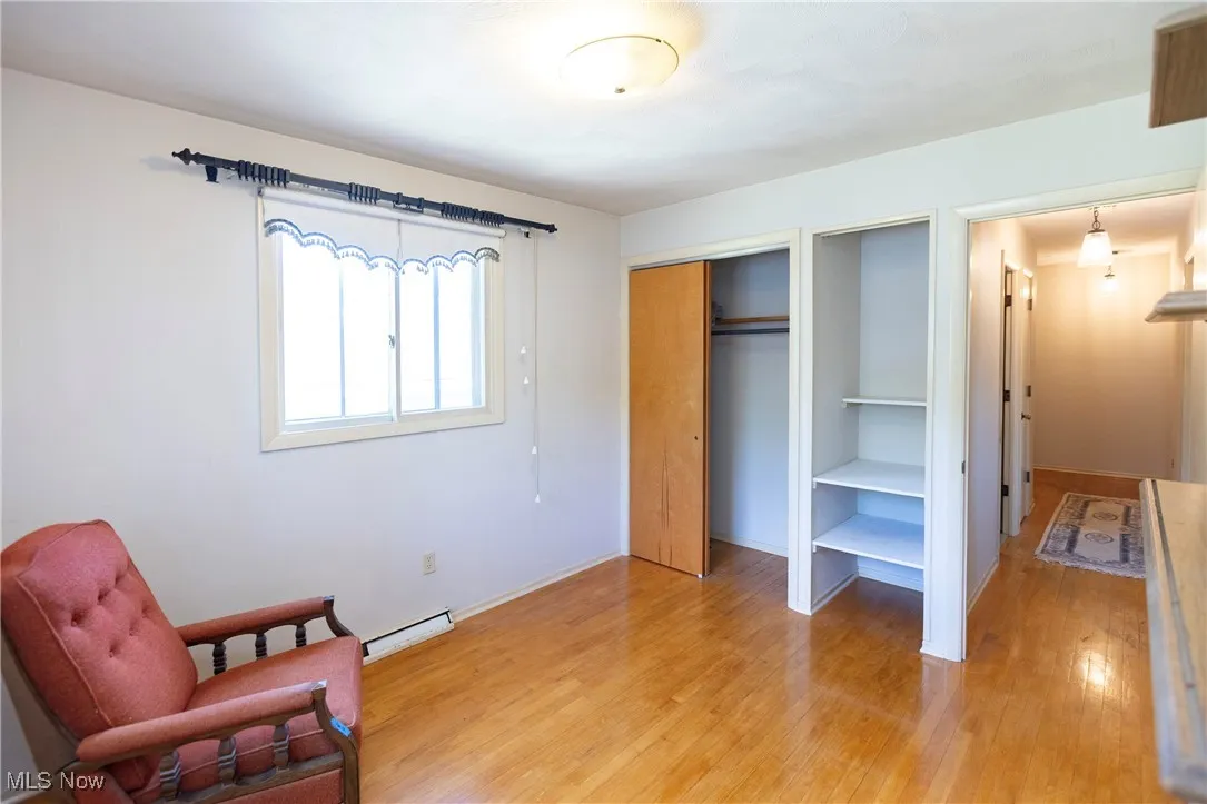 Bedroom featuring light wood-type flooring and a closet