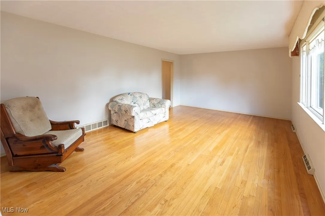 Sitting room featuring light wood finished floors and baseboards