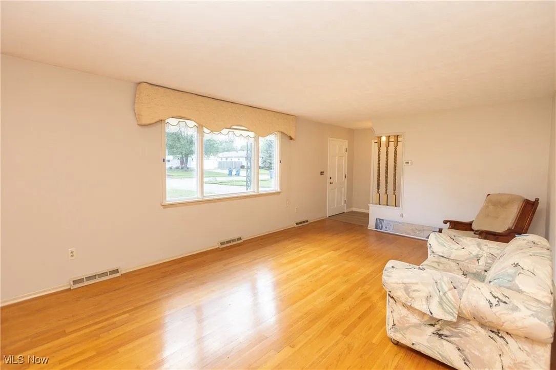 Living area with light wood-type flooring and baseboards