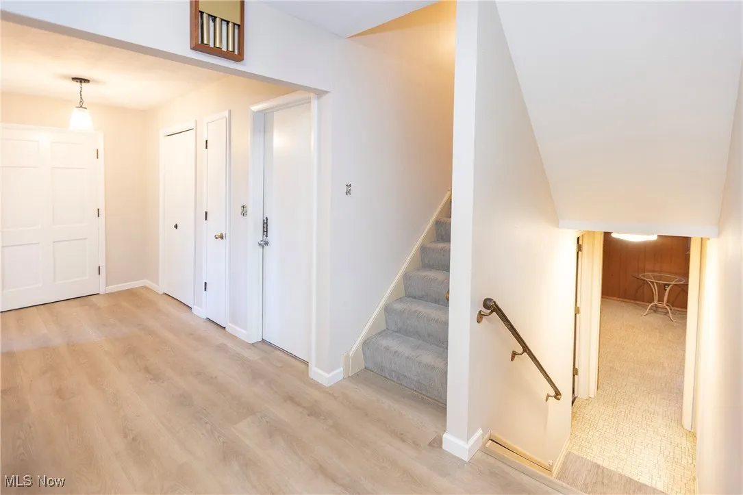 Staircase featuring wood finished floors and baseboards