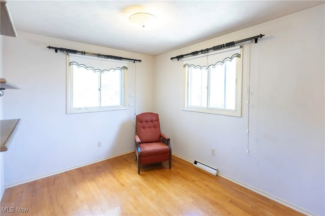 Unfurnished room featuring baseboards and light wood-style floors