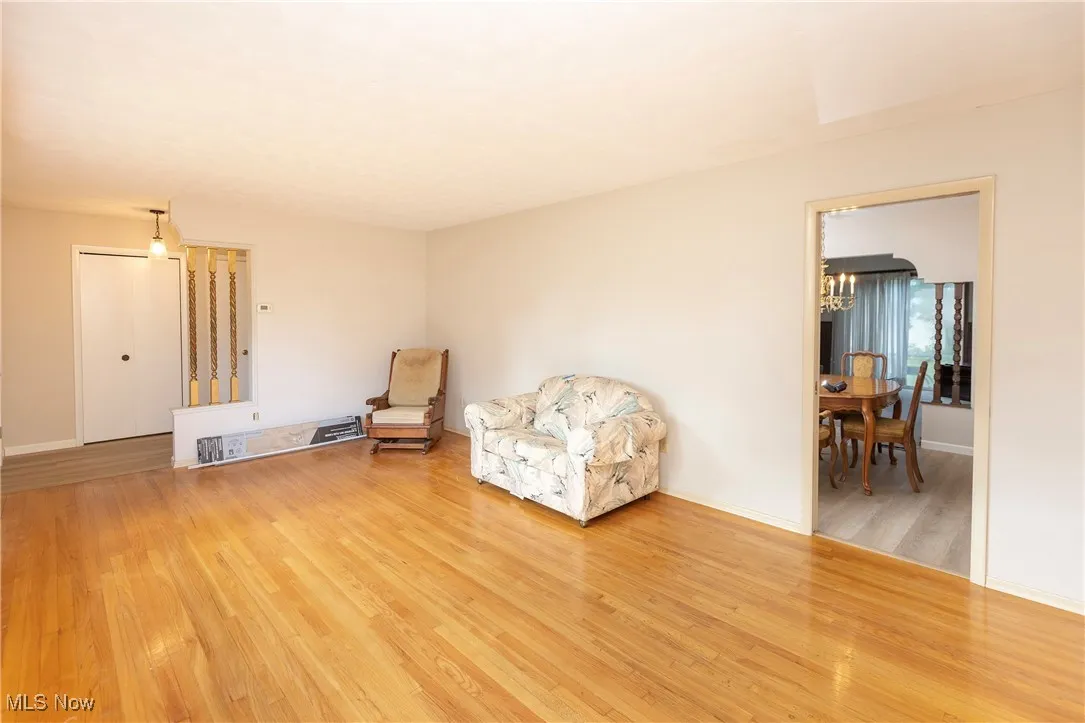 Sitting room featuring light wood-type flooring and a chandelier
