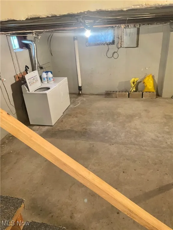Unfinished basement with independent washer and dryer and electric panel