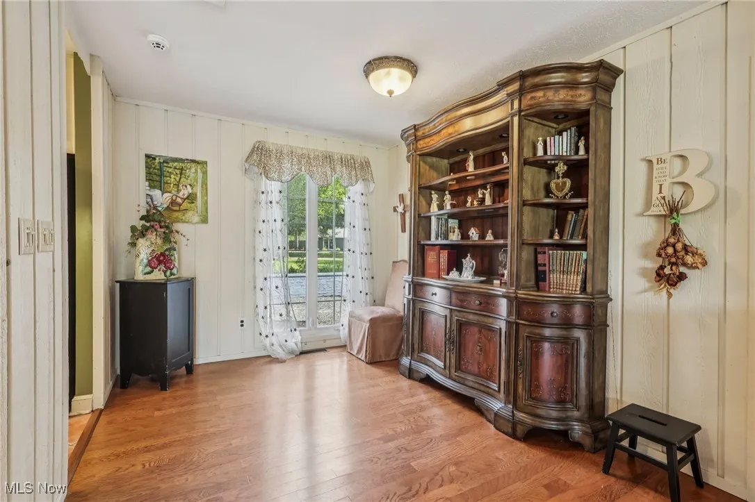 Living area featuring wood finished floors and wood walls