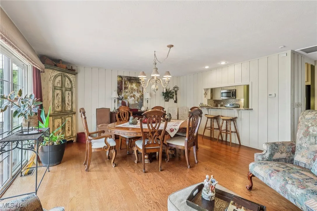 Dining room with light wood-style floors and a chandelier
