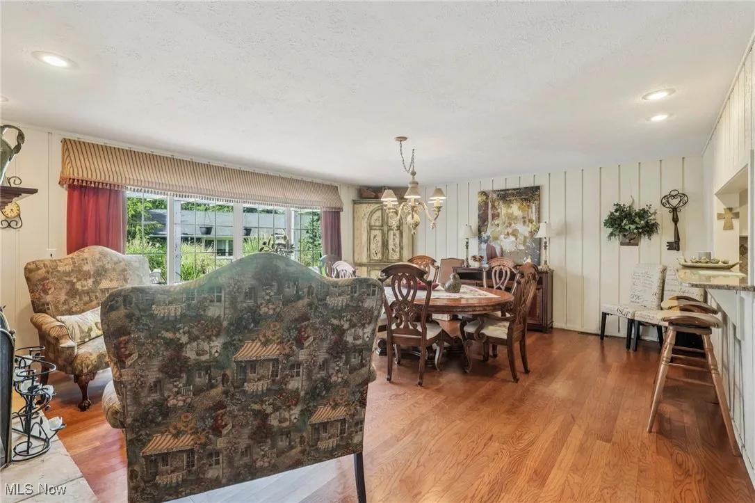 Dining space featuring light wood-type flooring, recessed lighting, a chandelier, and a textured ceiling