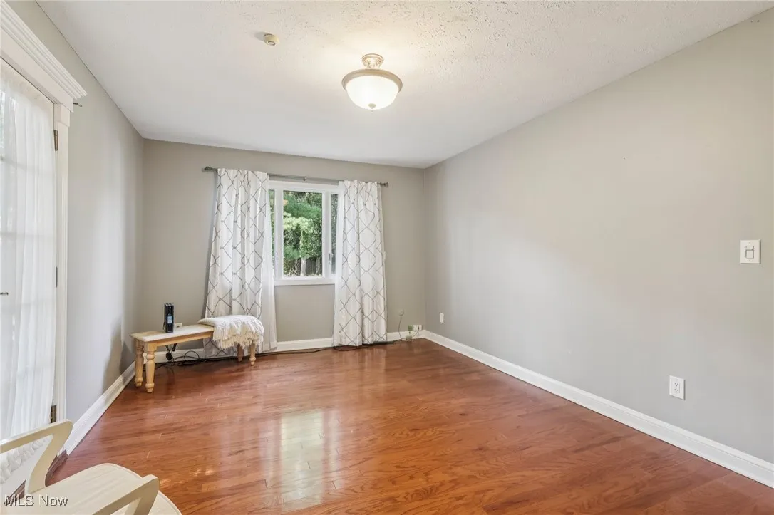 Sitting room featuring wood finished floors and a textured ceiling