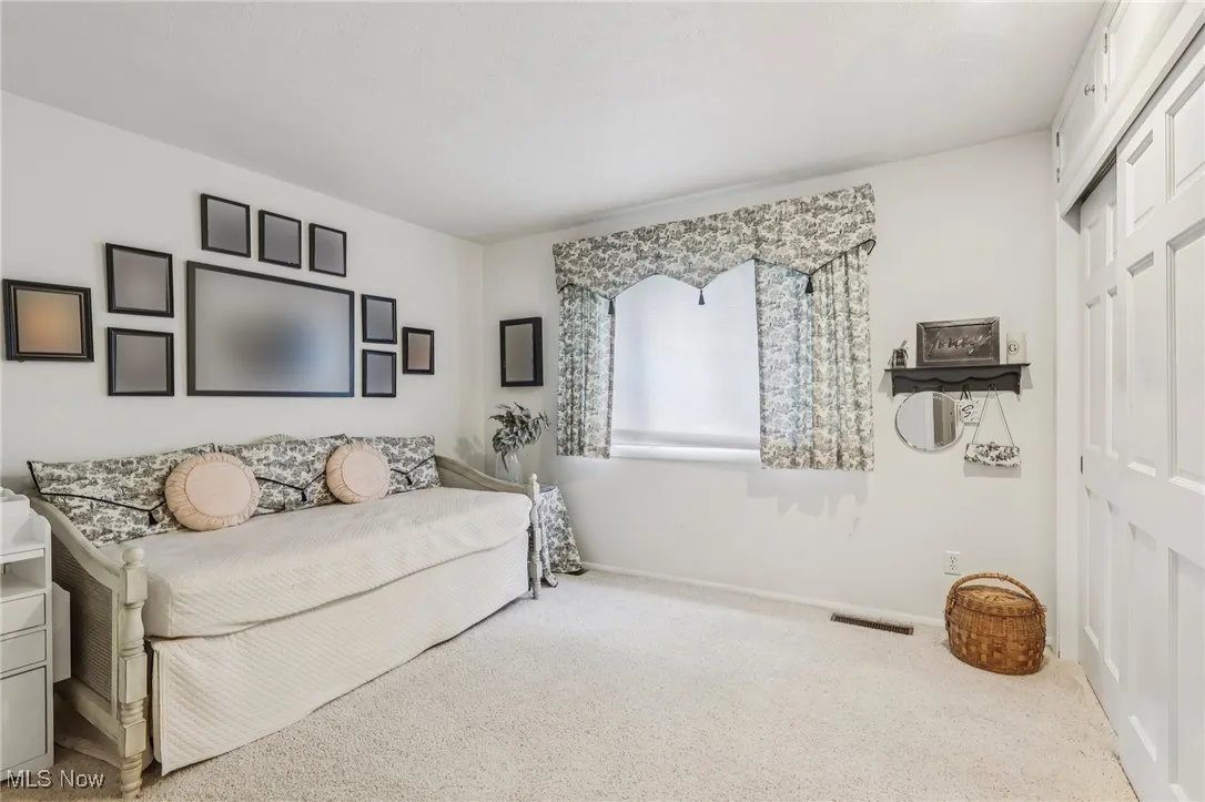 Bedroom featuring carpet flooring and a closet