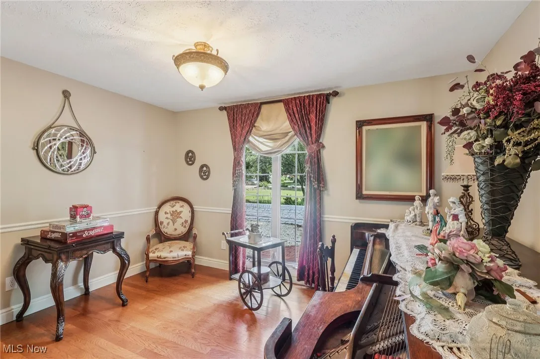 Living area with light wood-style flooring and a textured ceiling