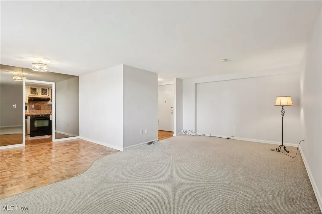 LR featuring baseboards and light carpet