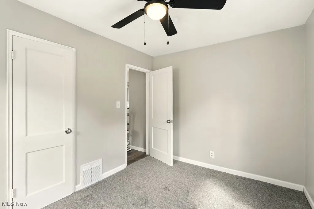Unfurnished bedroom with carpet and ceiling fan