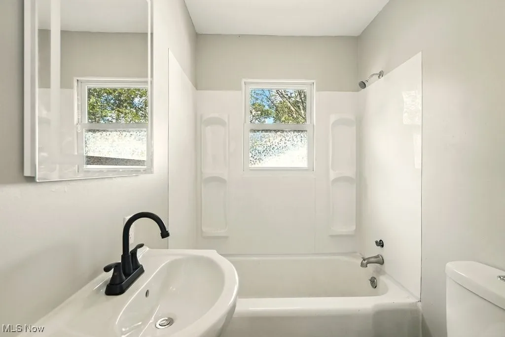 Full bath with shower / tub combination and toilet