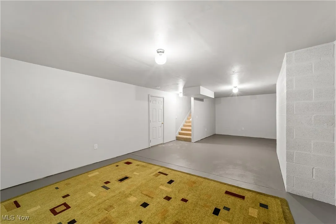 Finished basement featuring stairway