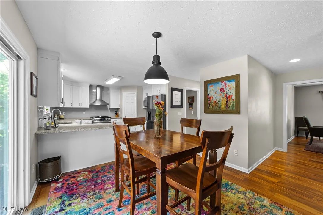 Dining space with dark wood-style flooring and a textured ceiling