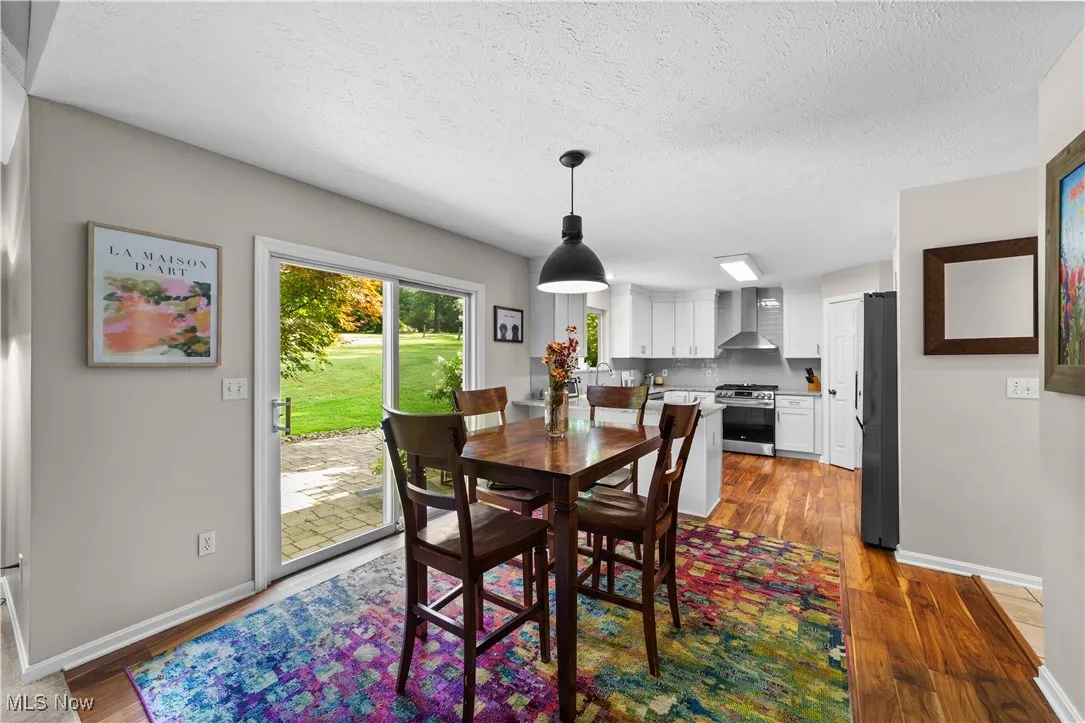 Dining space featuring dark wood-style flooring and a textured ceiling