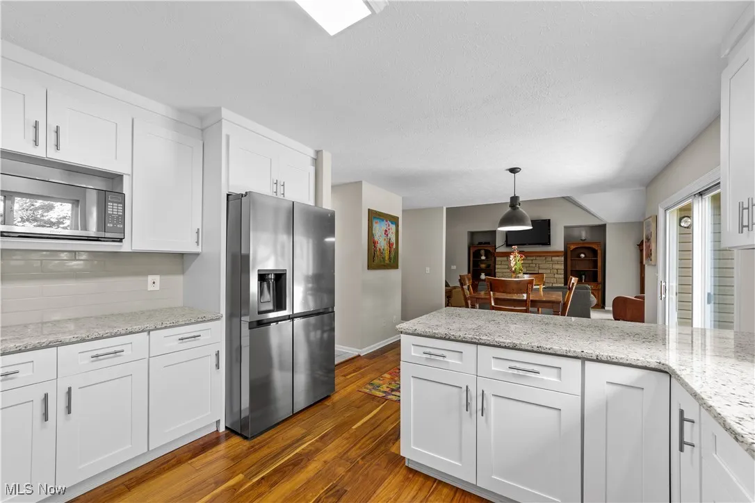 Kitchen featuring white cabinetry and decorative backsplash