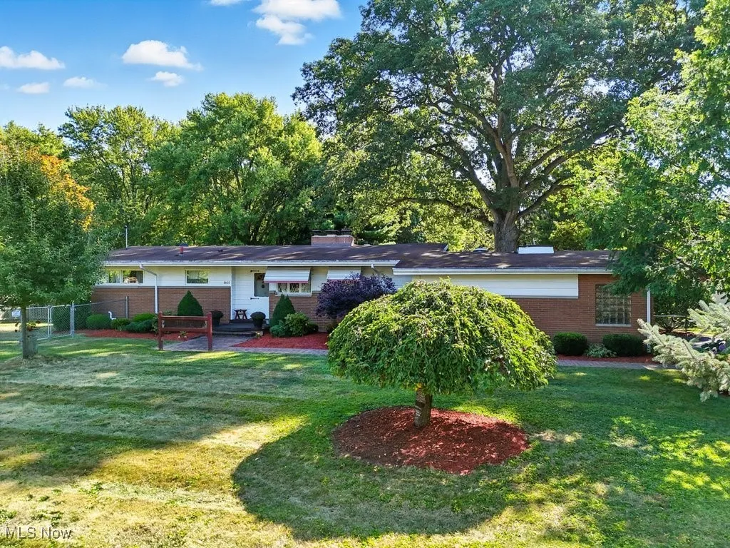 Back of property with brick siding and a chimney