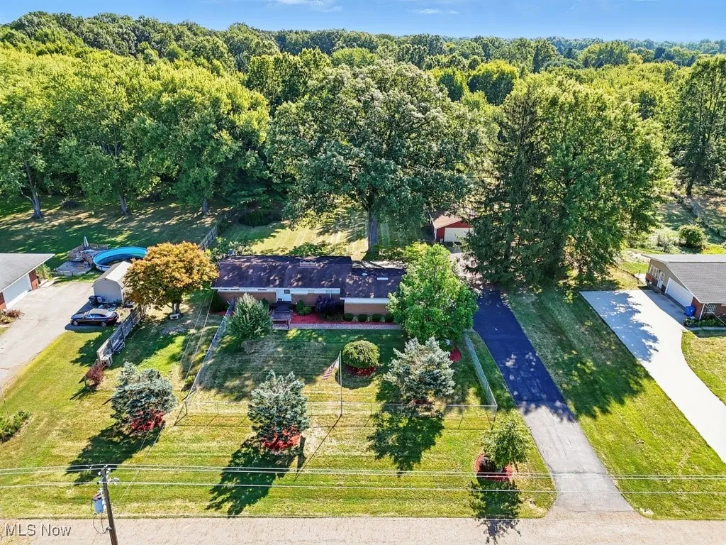 View of subject property with a forest